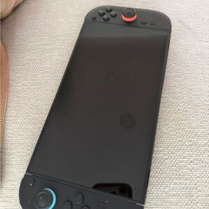 Sleek Black Handheld Gaming Console with Blue and Red Accents